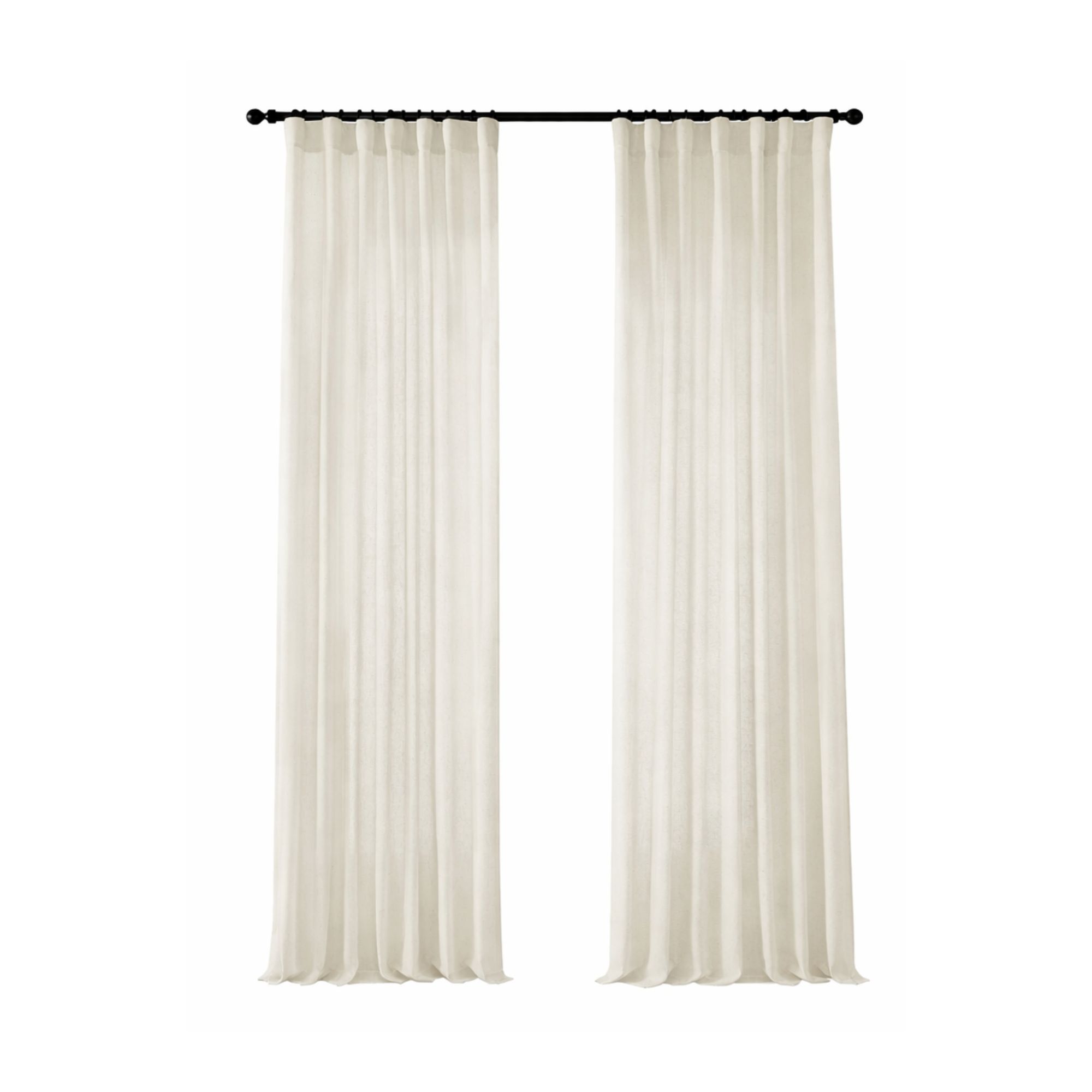 Cream curtain panels hanging on a black curtain rod demonstrating proper curtain height and drapery styling