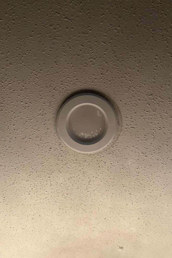 LED recessed can light installed in ceiling with light turned off