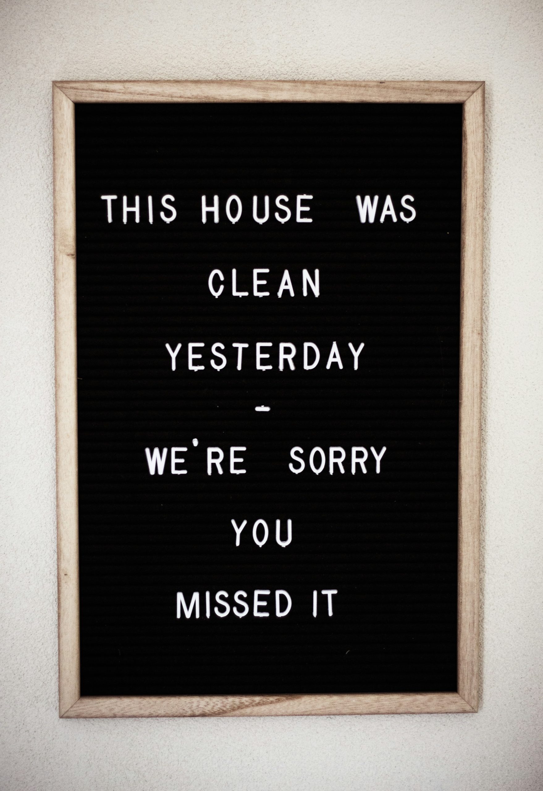 Black letter board with a humorous quote about resetting your home and keeping a clean space.