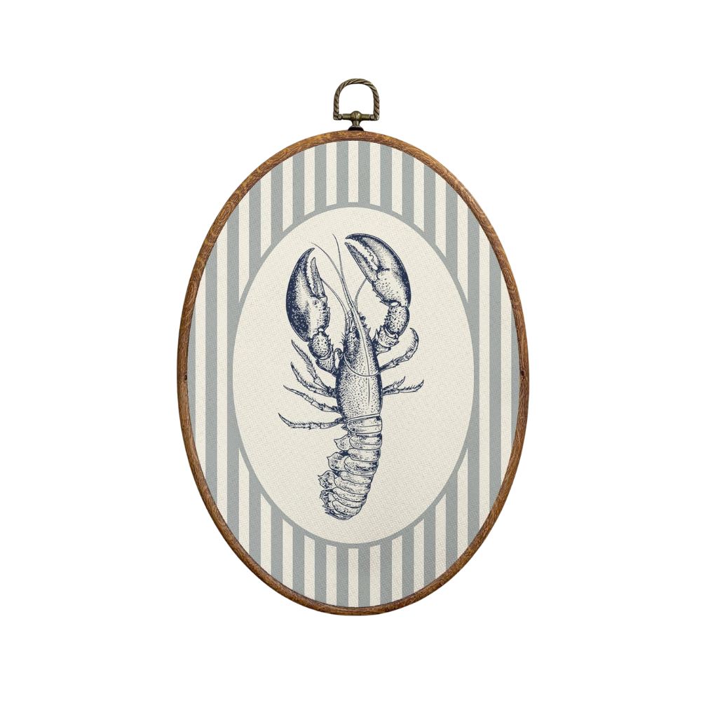 Vintage-inspired lobster artwork in an oval frame with striped detailing for subtle coastal charm.