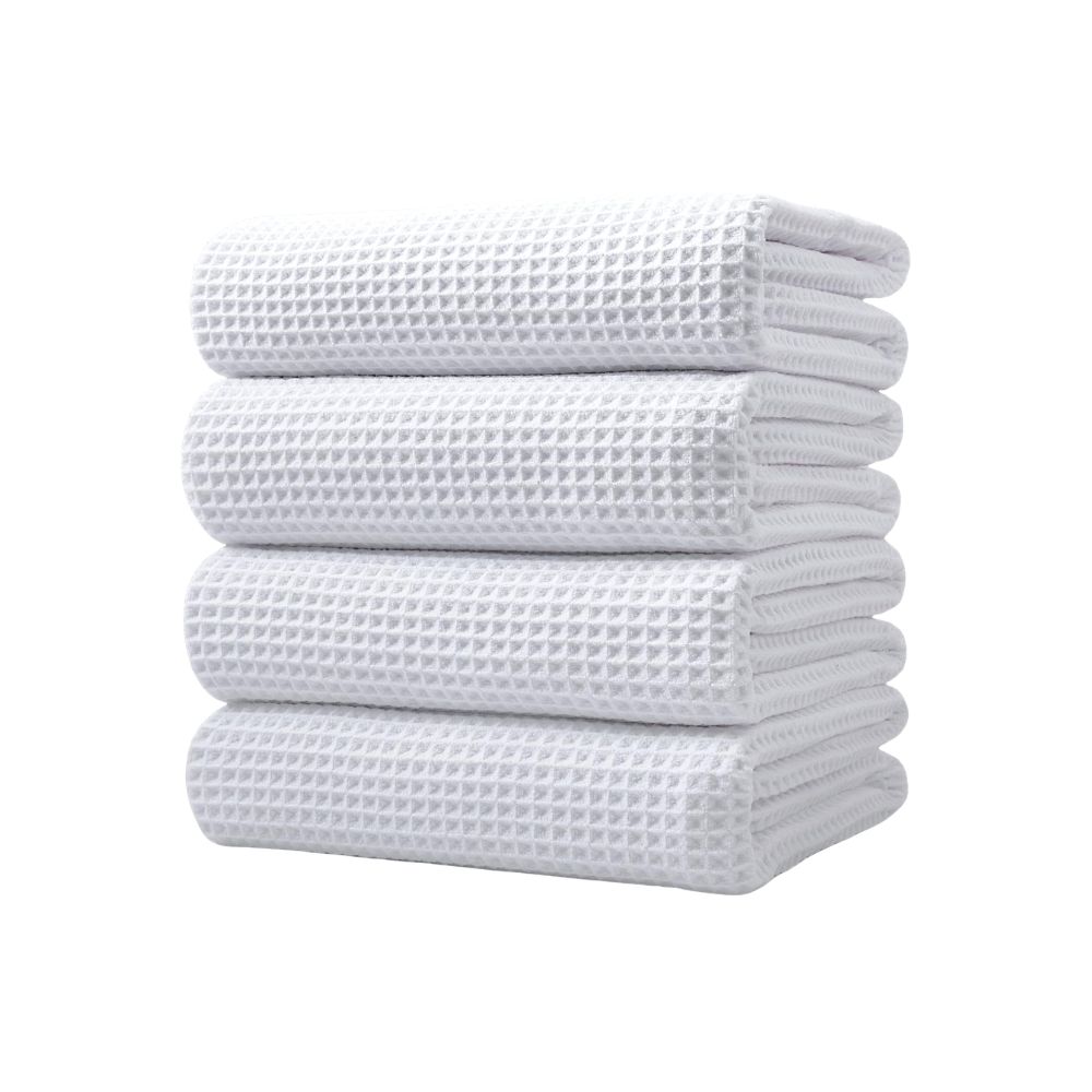 Stack of white waffle weave towels for a guest bathroom